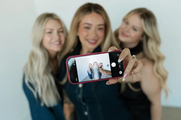 Three stylists taking a group selfie