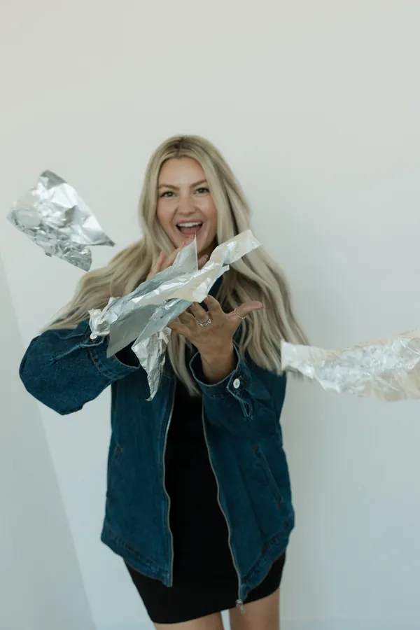 Stylist tossing foils in the air