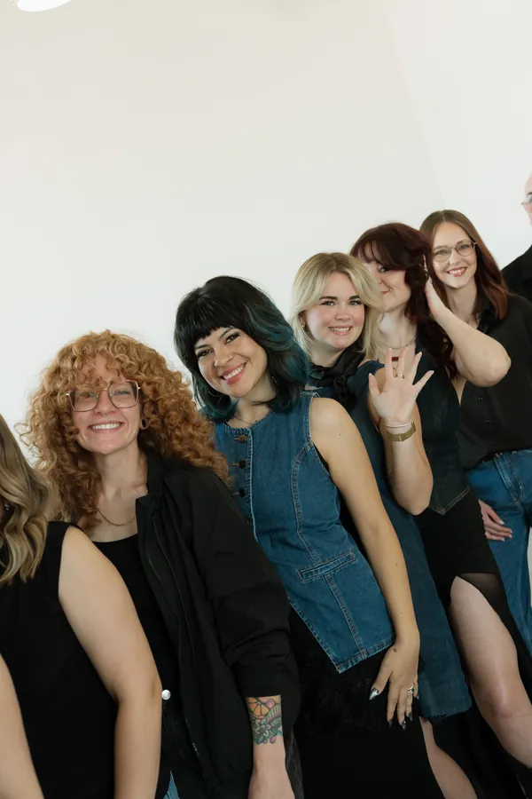 Stylists laughing together in a close group